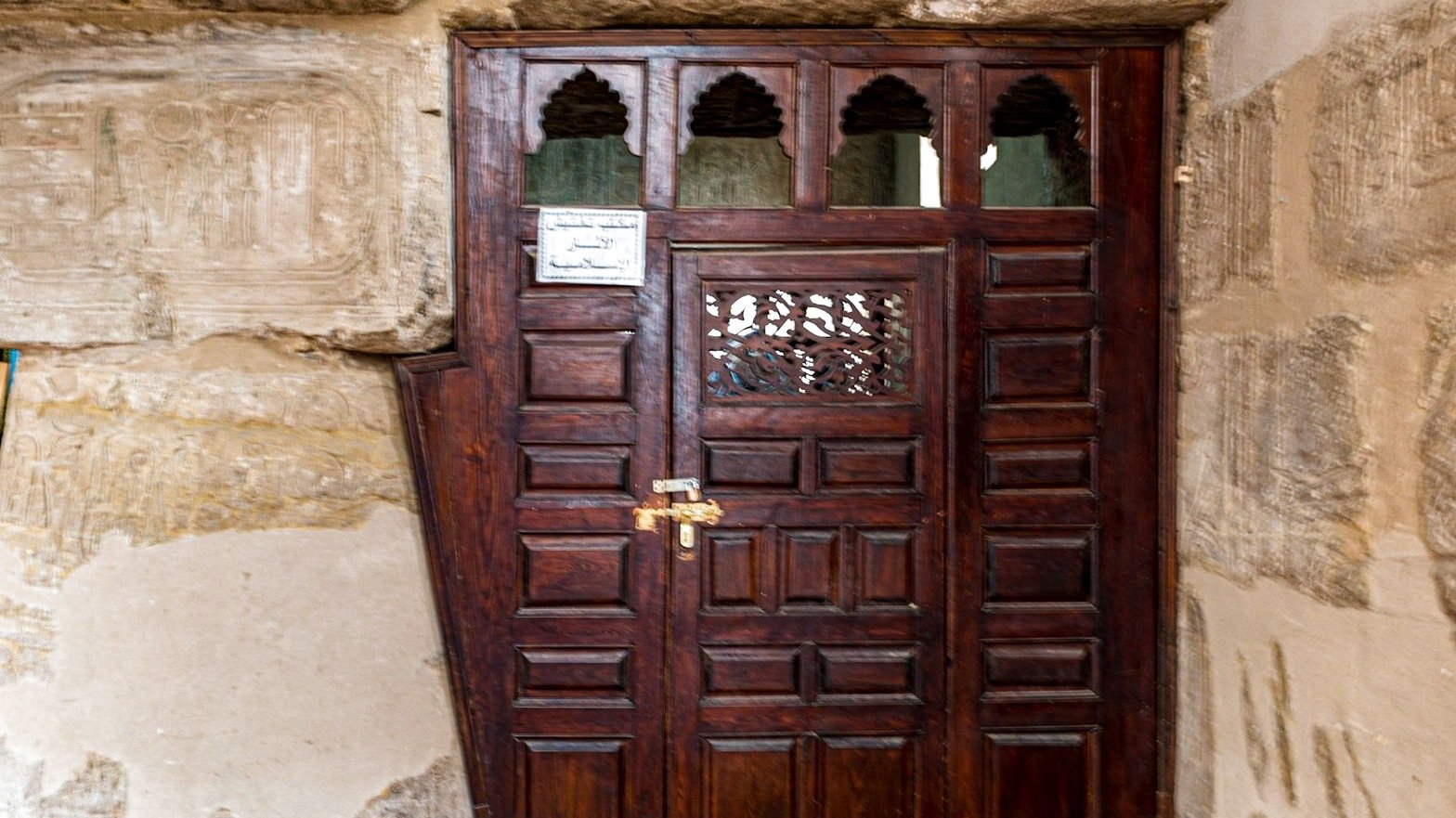 Wooden doorway framed by ancient stone