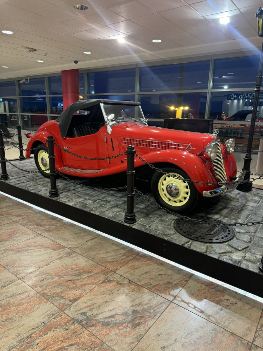 A red vintage car on indoor display
