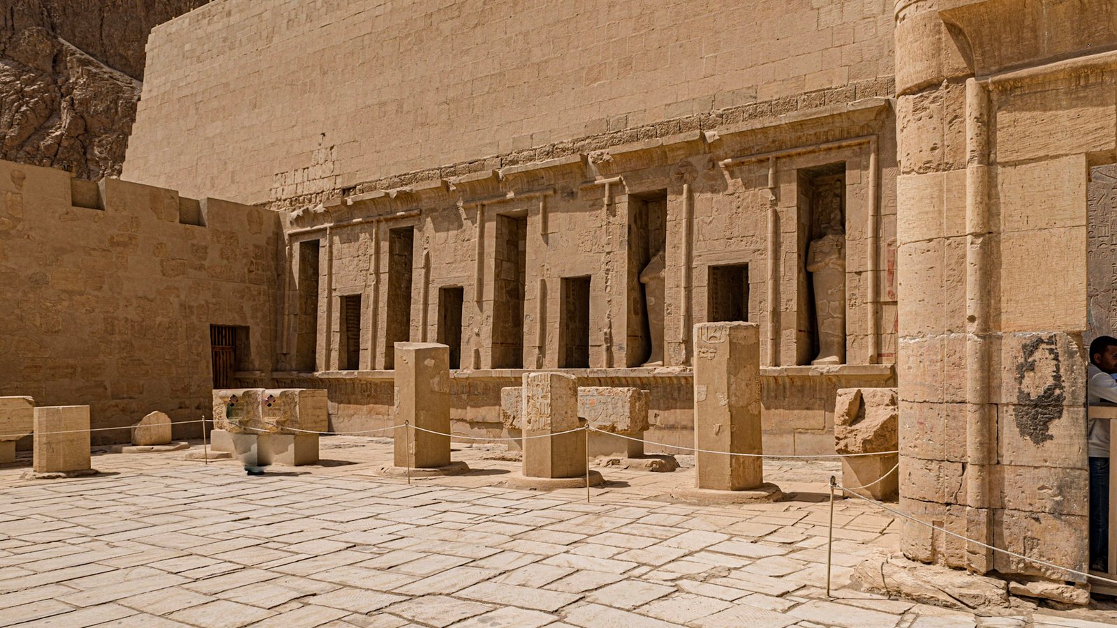 Sunlit courtyard beneath the cliffs of Deir el-Bahari