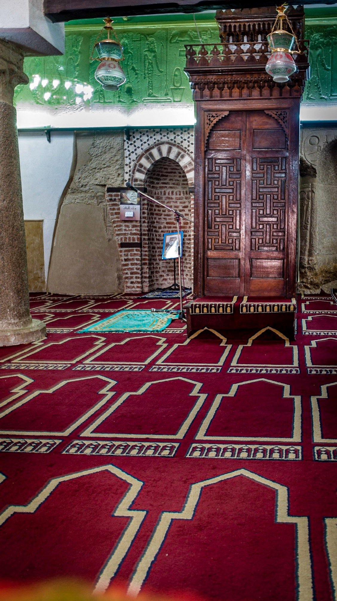 Prayer hall with carpet and wooden minbar