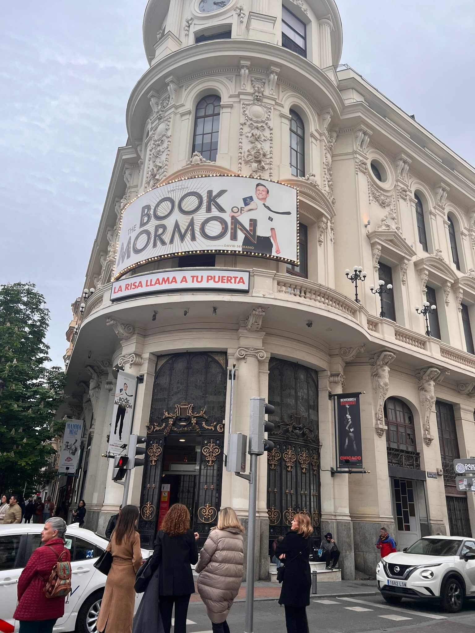 Rounded corner building with a theatre advertisement.