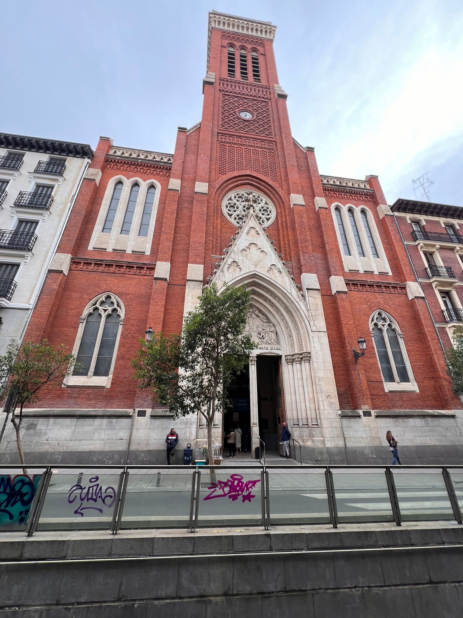 Red-brick church façade with a rose window.
