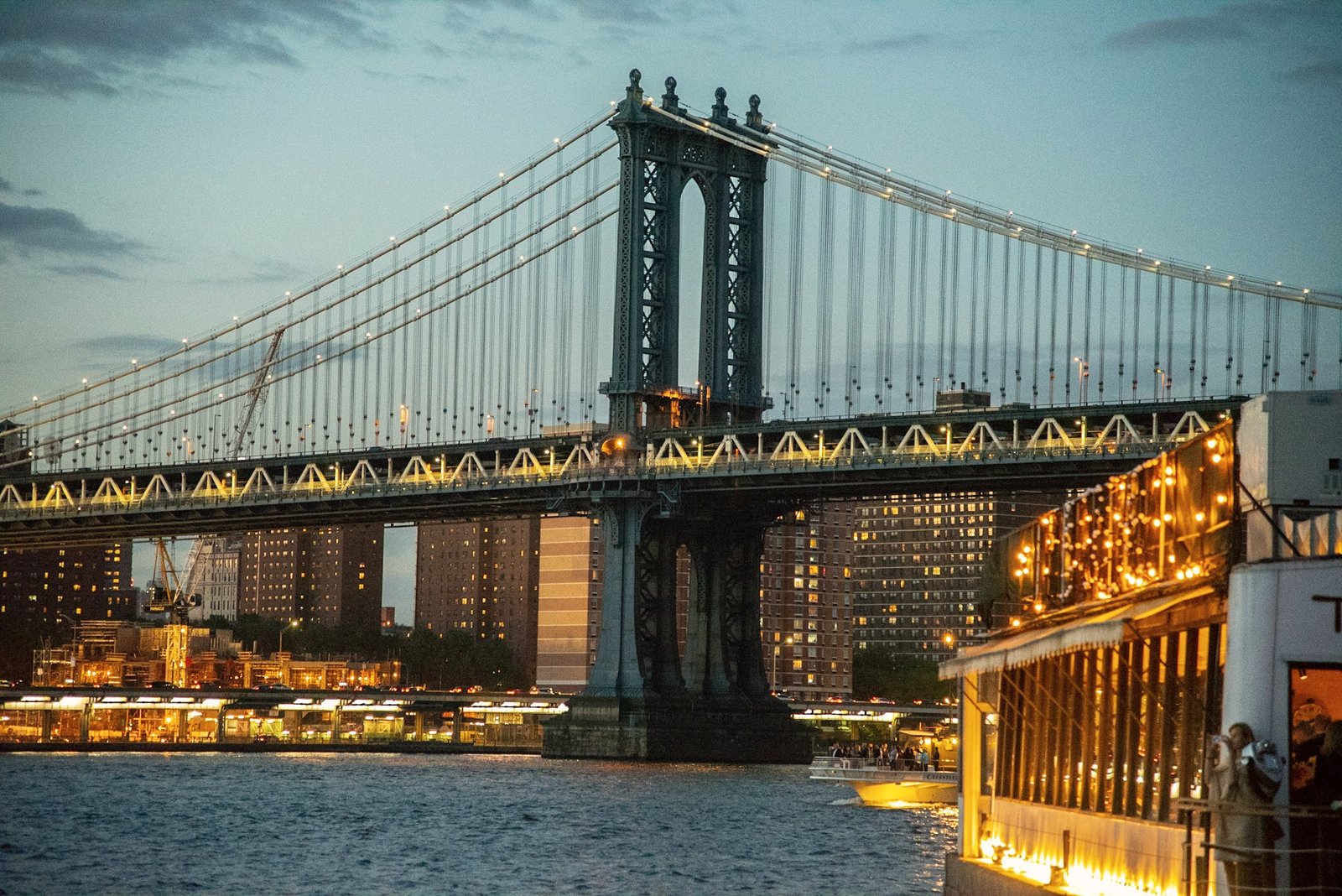 Manhattan Bridge tower and suspension cables at dusk.